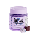 Jar of 'lemme RELAX' magnesium complex soft chews with a single chew on a white background