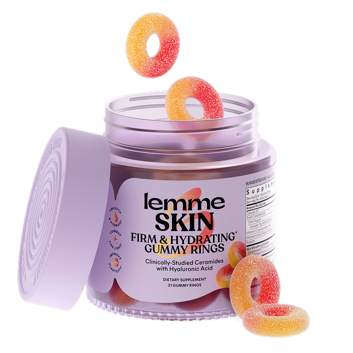 A jar of Lemme Skin Gummy Rings on a white background, with several gummy rings floating above and resting around the open container. The jar is light purple with a matching lid leaning against it, and the label reads 'lemme SKIN FIRM & HYDRATING GUMMY RINGS'.