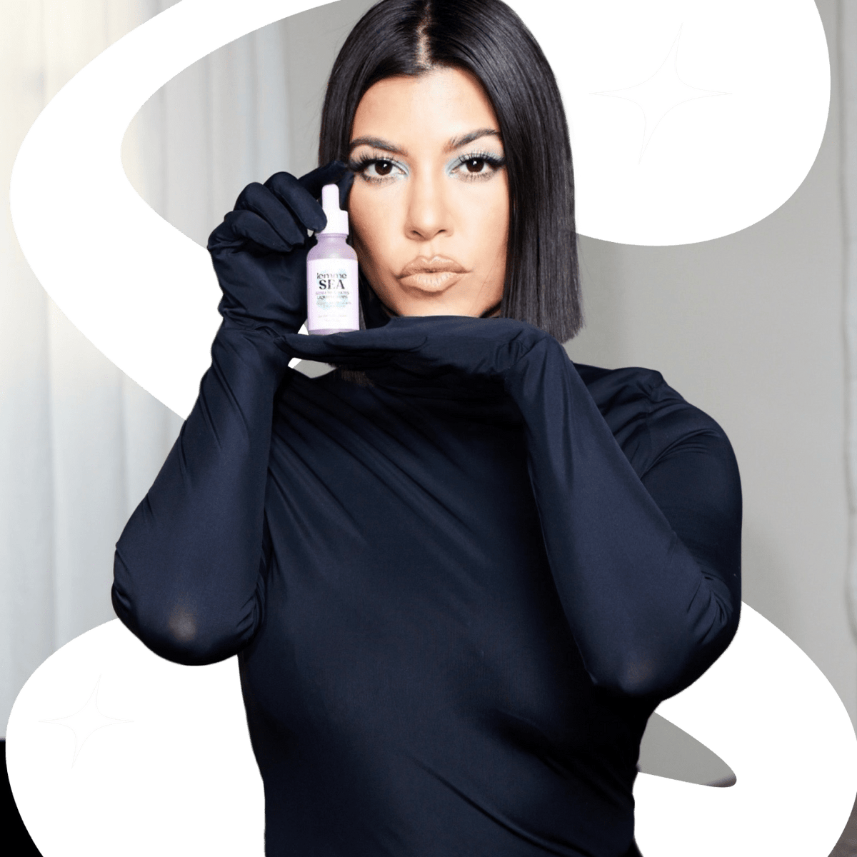 Kourtney wearing black holding a bottle of seamoss 