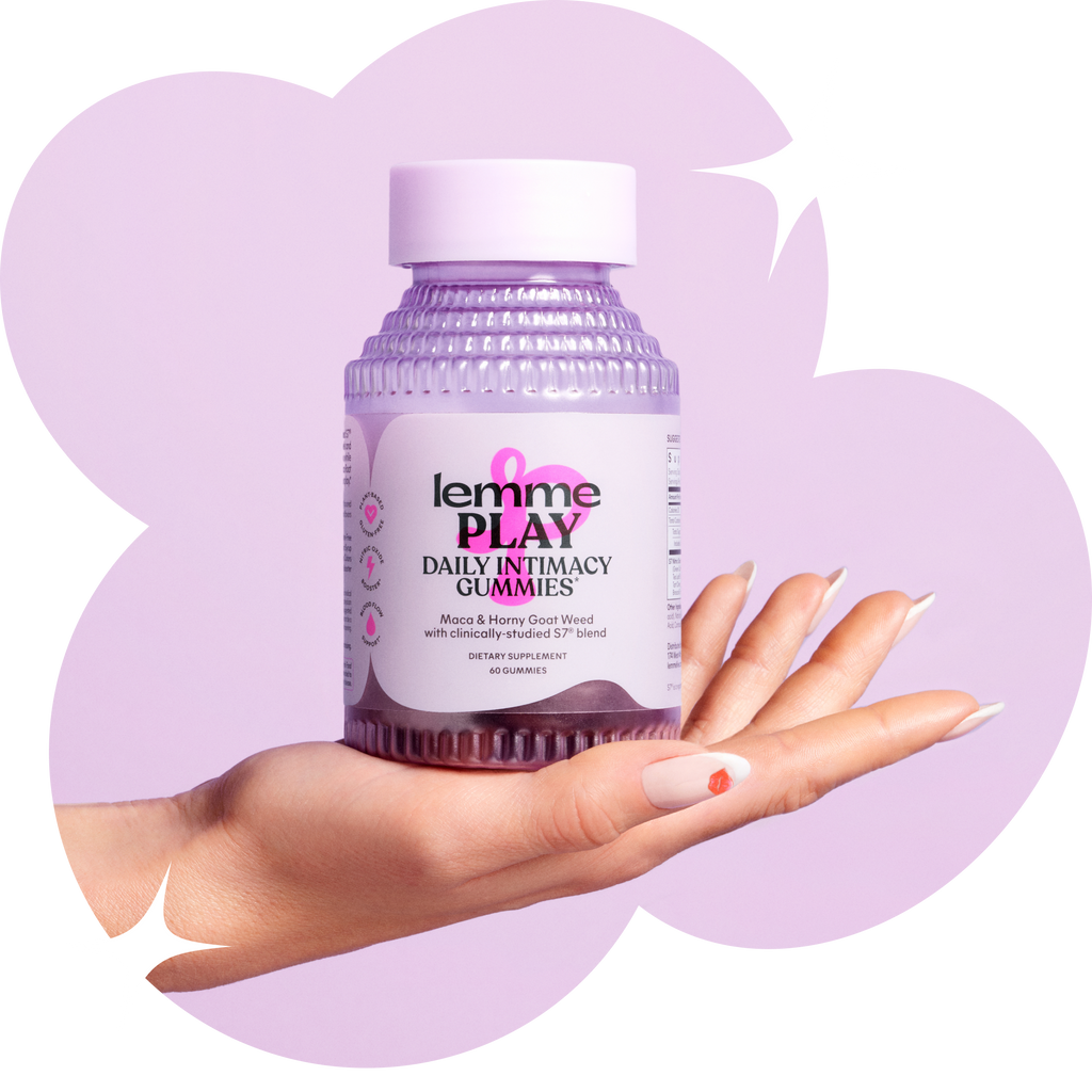 Bottle of daily intimacy gummies held in a hand against a purple background.